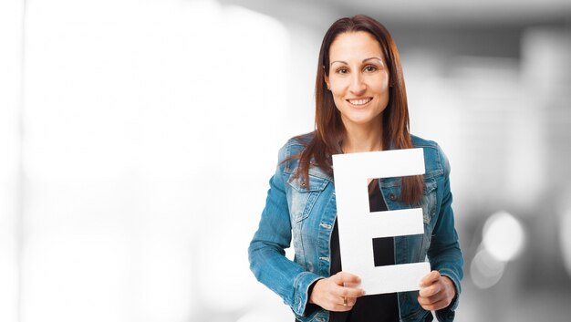 Woman smiling holding the letter "e"