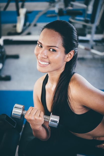 Woman smiling lifting weights