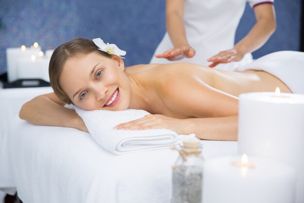 Woman smiling while giving her a back massage