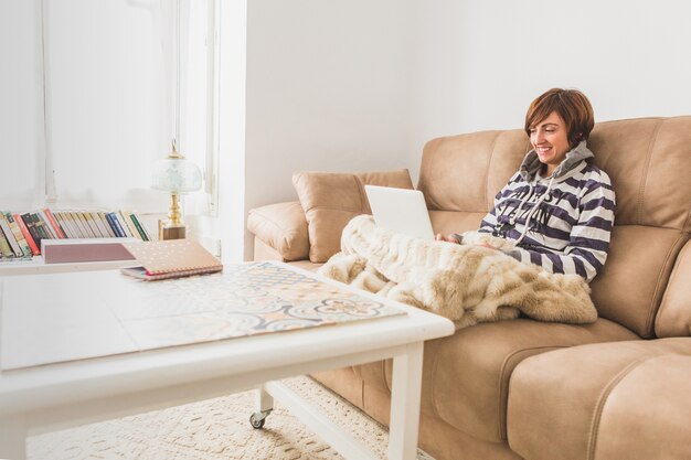 Woman smiling while using her laptop