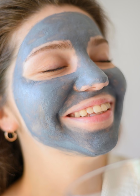 Woman smiling while wearing face mask