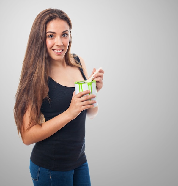 Woman smiling with a can of green paint