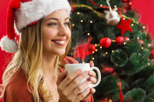 Woman smiling with a cup of coffee in hands