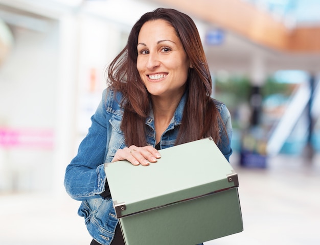 Woman smiling with a green box