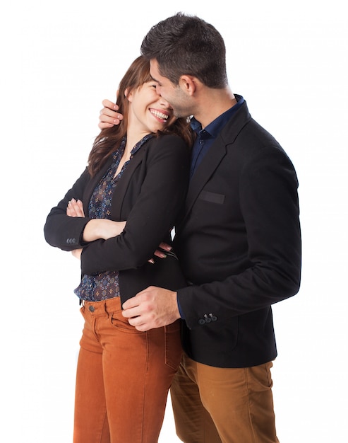 Woman smiling with a man embracing her