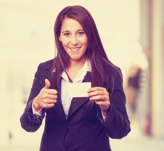 Free photo woman smiling with a thumb up and a business card
