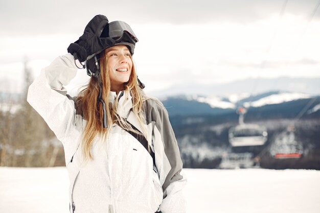 Woman in snowboard suit. Sportswoman on a mountain with a snowboard in the hands on the horizon. Concept on Sports