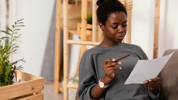 Woman on the sofa making a plan to redecorate house