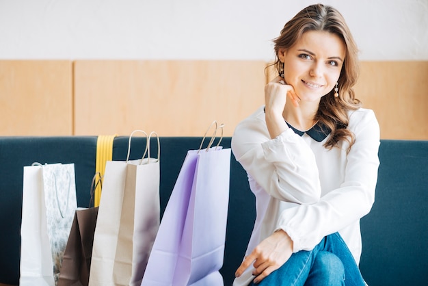 Woman on sofa near paper bags