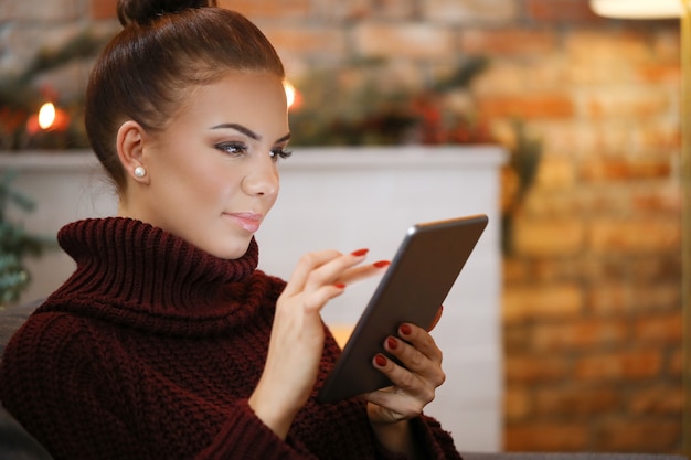 Woman on the sofa with a tablet