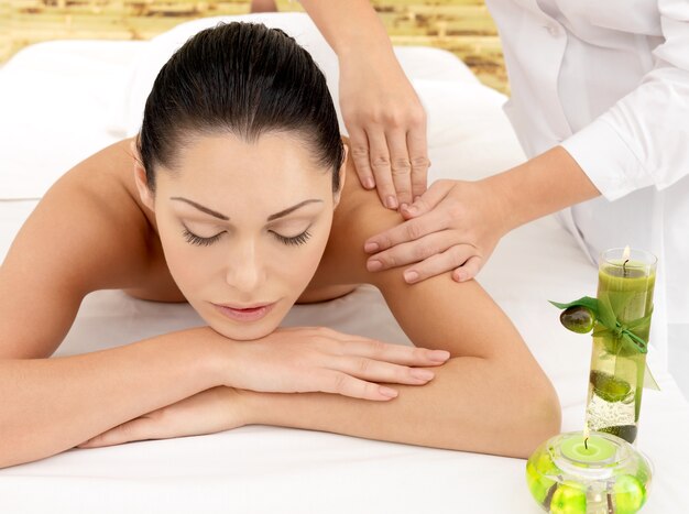 Woman on spa massage of shoulder in the beauty salon.