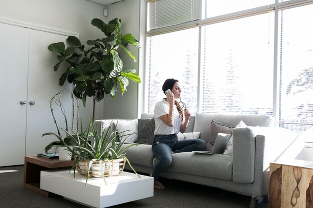 Woman speaking on phone on sofa