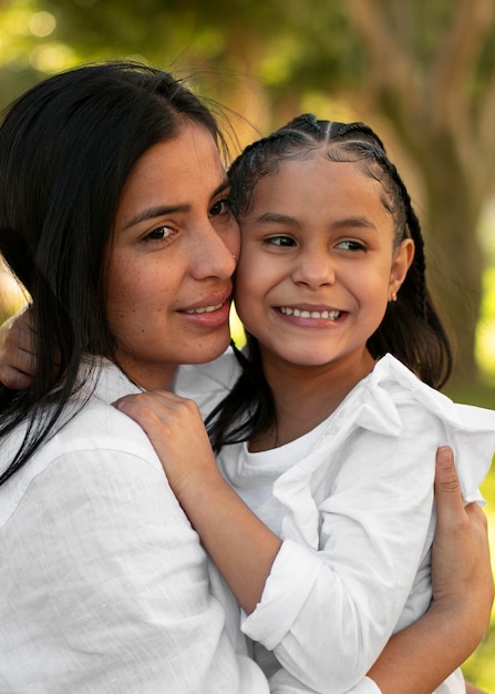 Free photo woman spending mothers day with her daughter outdoors in the park