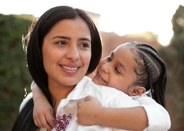 Woman spending mothers day with her daughter outdoors in the park