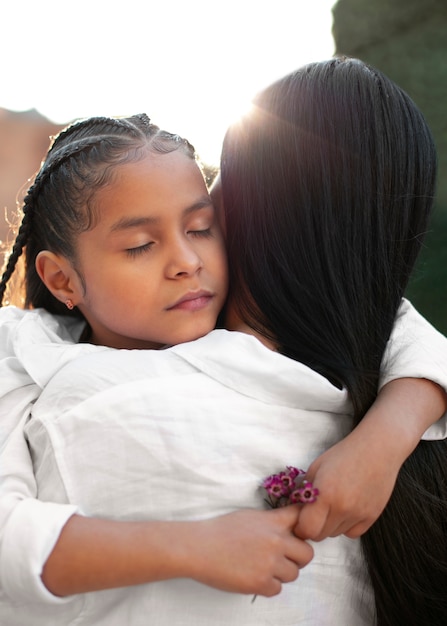 Free photo woman spending mothers day with her daughter outdoors in the park