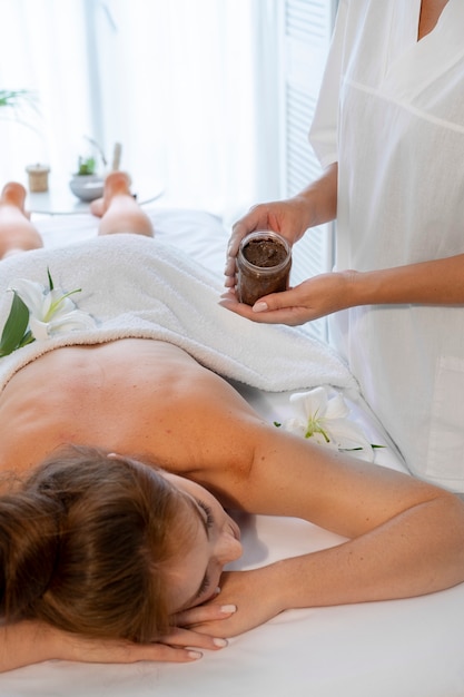 Woman spending time at the spa and getting an exfoliation massage
