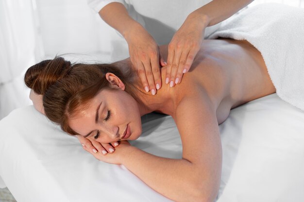 Woman spending time at the spa and getting a relaxing massage