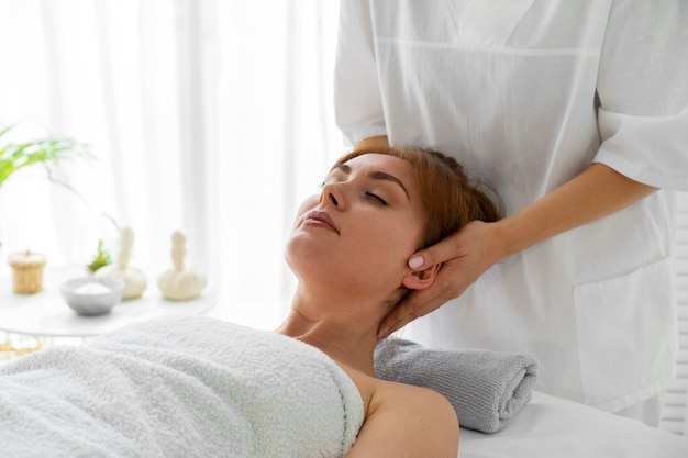 Woman spending time at the spa and getting a relaxing massage