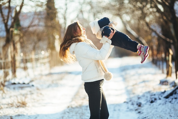 Woman spinning with her baby in hands