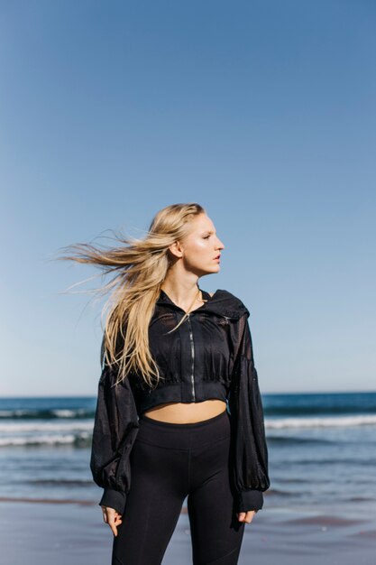 Woman in sports clothes at the beach