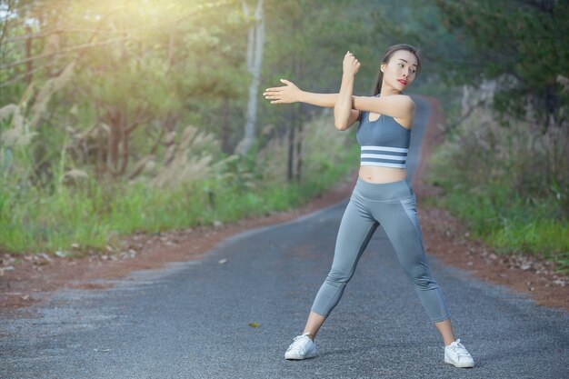 woman in sportswear doing exercises outdoors