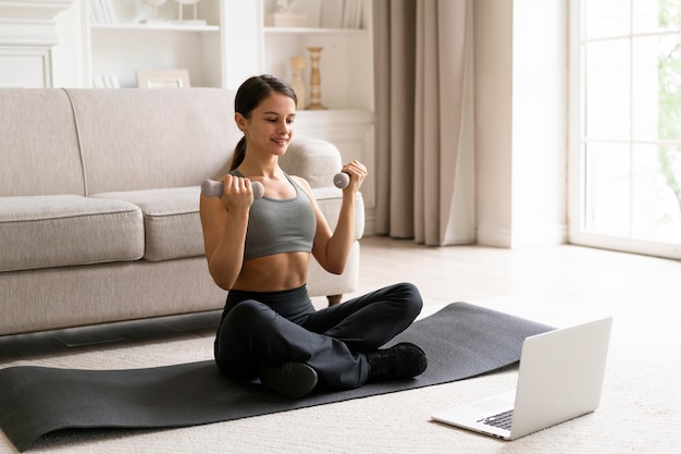 Woman in sportswear exercising at home