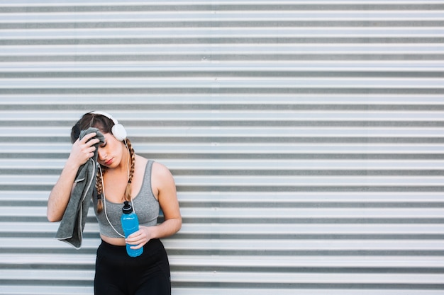 Woman in sportswear wiping face