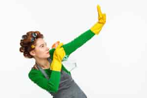 Free photo woman spraying windows and posing with yellow rubber on hands