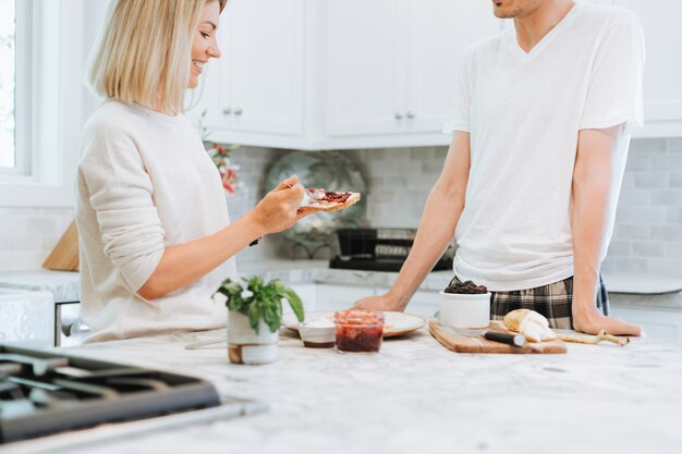 Woman spreading vegan cream cheese on a toast