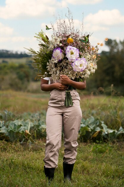 Woman in the spring holding bouquet of flowers