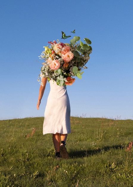 Woman in the spring holding bouquet of flowers