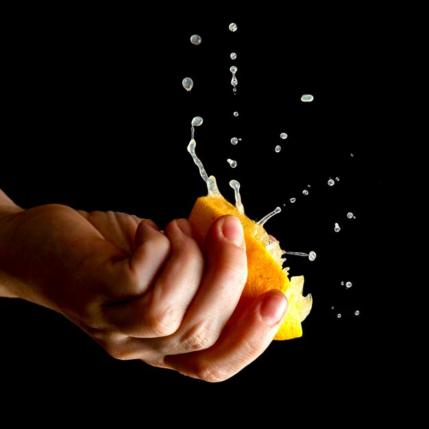 Woman squeezing lemon close-up