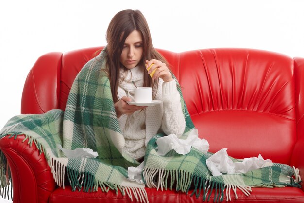 Woman squeezing a lemon in her cup of tea