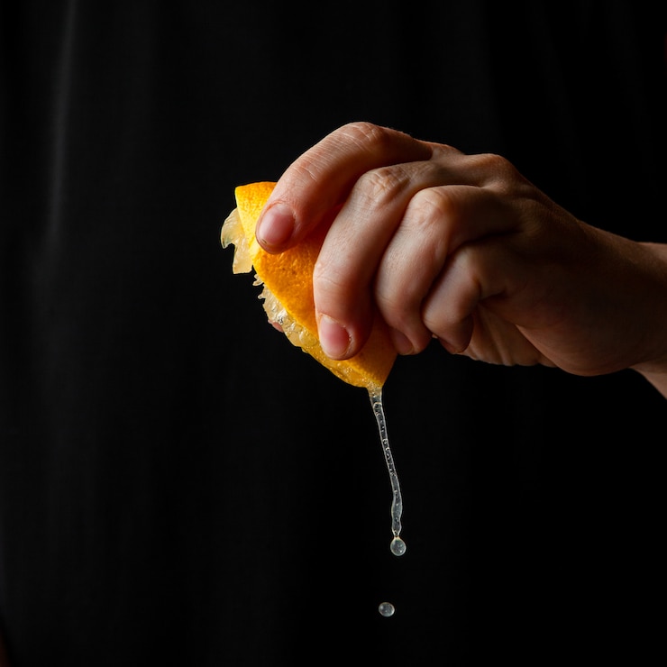 Free Photo woman squeezing lemon