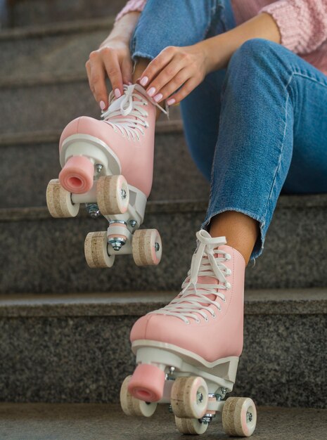 Woman on stairs putting on roller skates