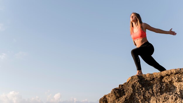 Woman standing on a coast with copy space