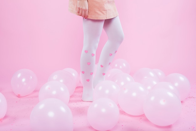 Free photo woman standing on floor with balloons