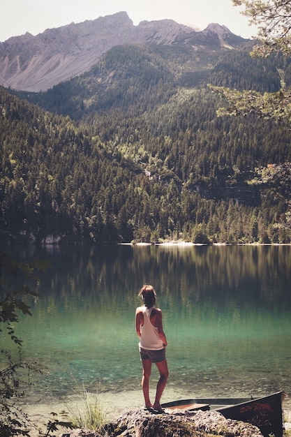 Woman standing in front of body of water