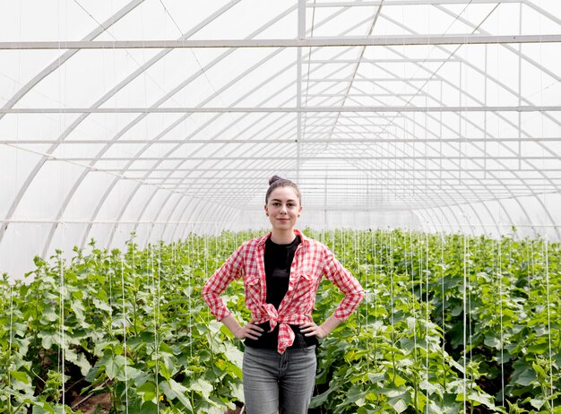 Woman standing in front of a greenhouse