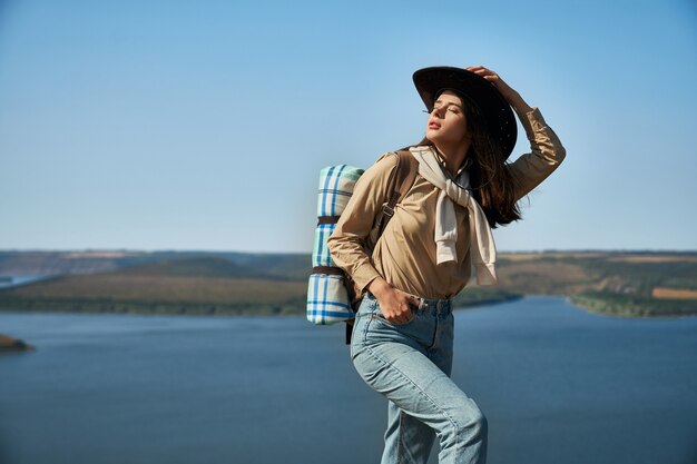 Woman standing on peak of mountain with closed eyes