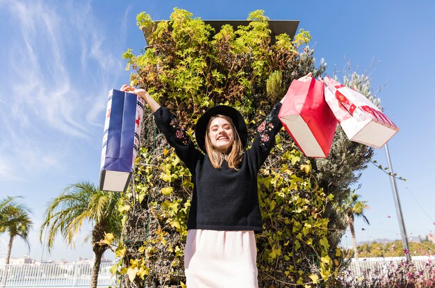 Woman standing on street with shopping bags