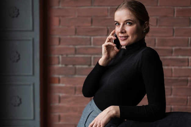 Free photo woman standing talking over phone