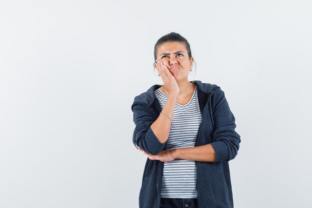 Woman standing in thinking pose in t-shirt