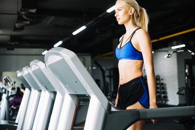 Woman standing on treadmill