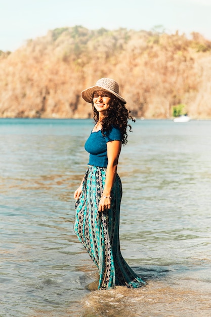 Woman standing in water by ocean