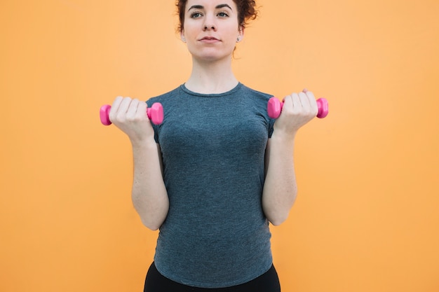 Woman standing with dumbbells