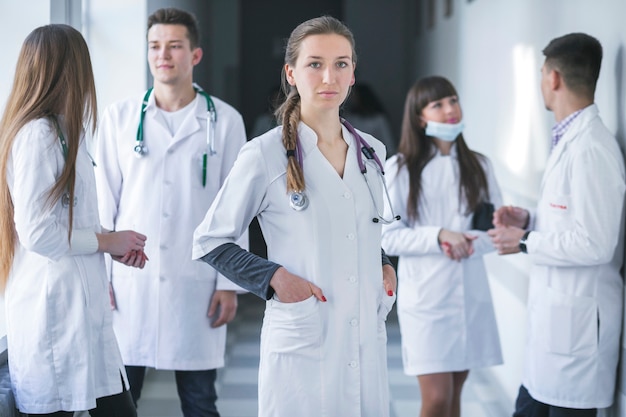 Woman standing with medic colleagues