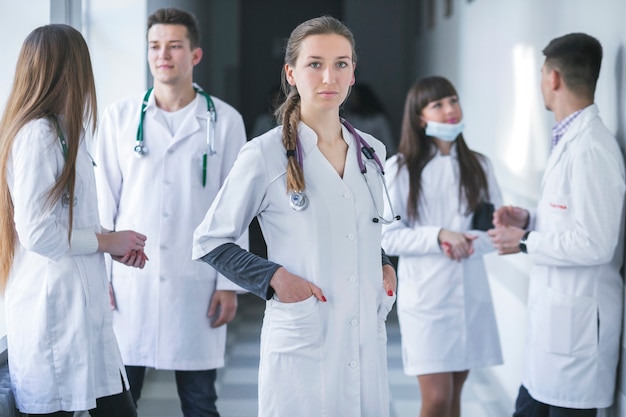 Free Photo woman standing with medic colleagues