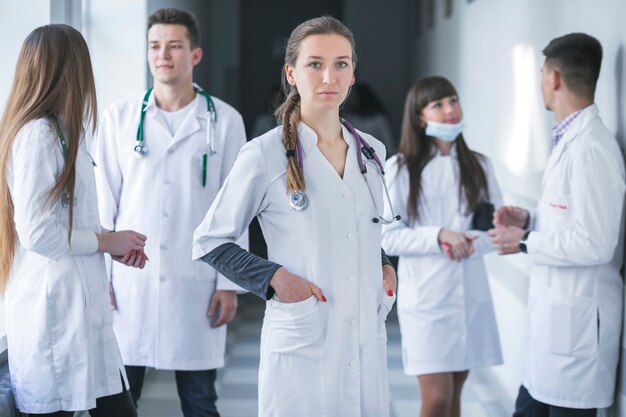 Woman standing with medic colleagues