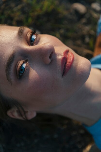 Woman staring at camera with bright face and blue eyes